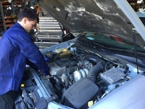 Hytech Parts Plus Employee Working on a Car